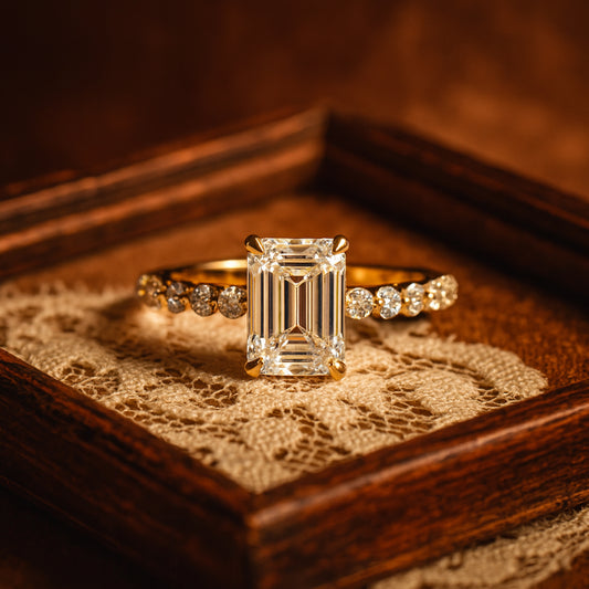 Elegant Emerald Cut Moissanite Ring Featuring A Classic Gold Band And Brilliant Side Accents