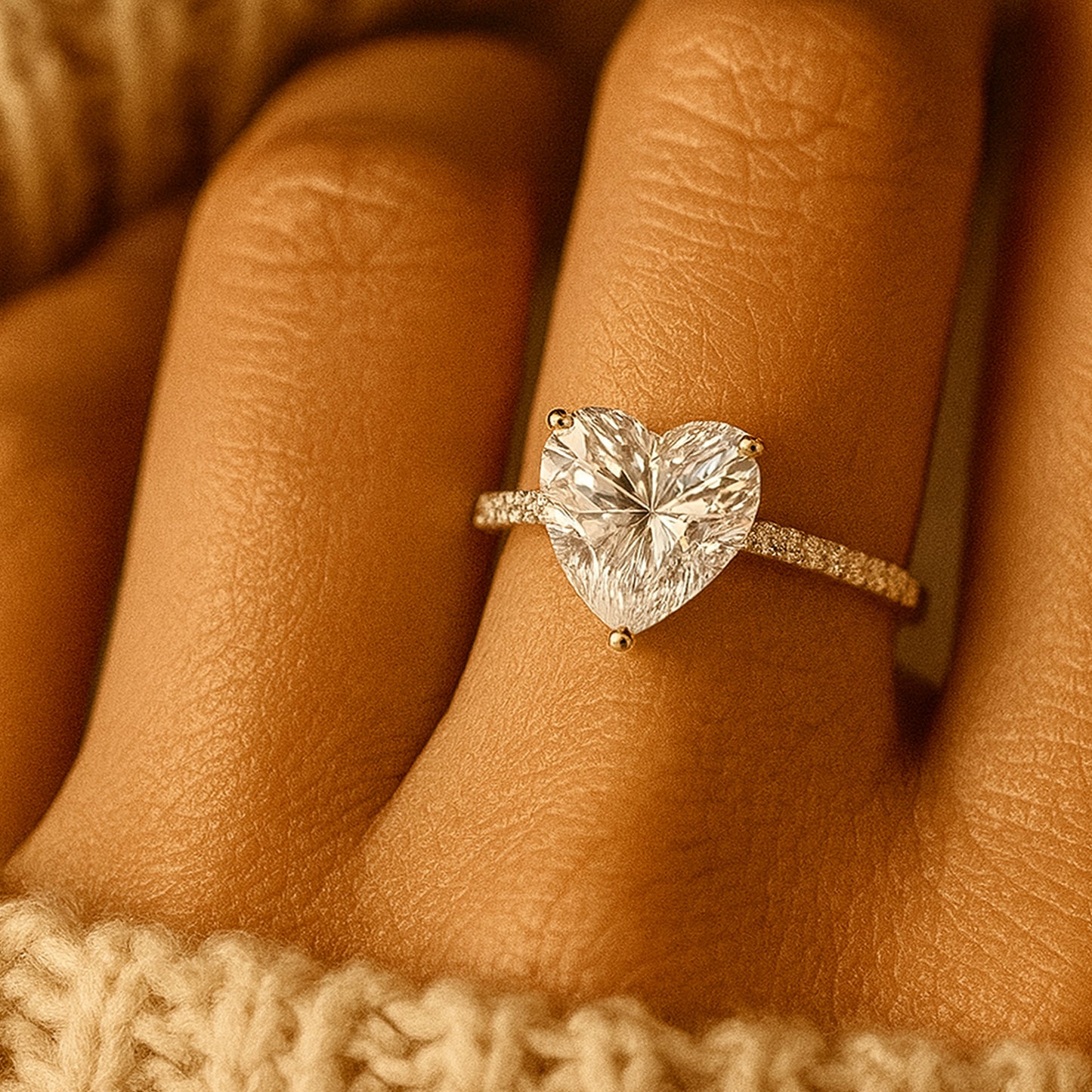 Diiro heart-shaped diamond solitaire ring in gold with delicate pavé band for timeless elegance.