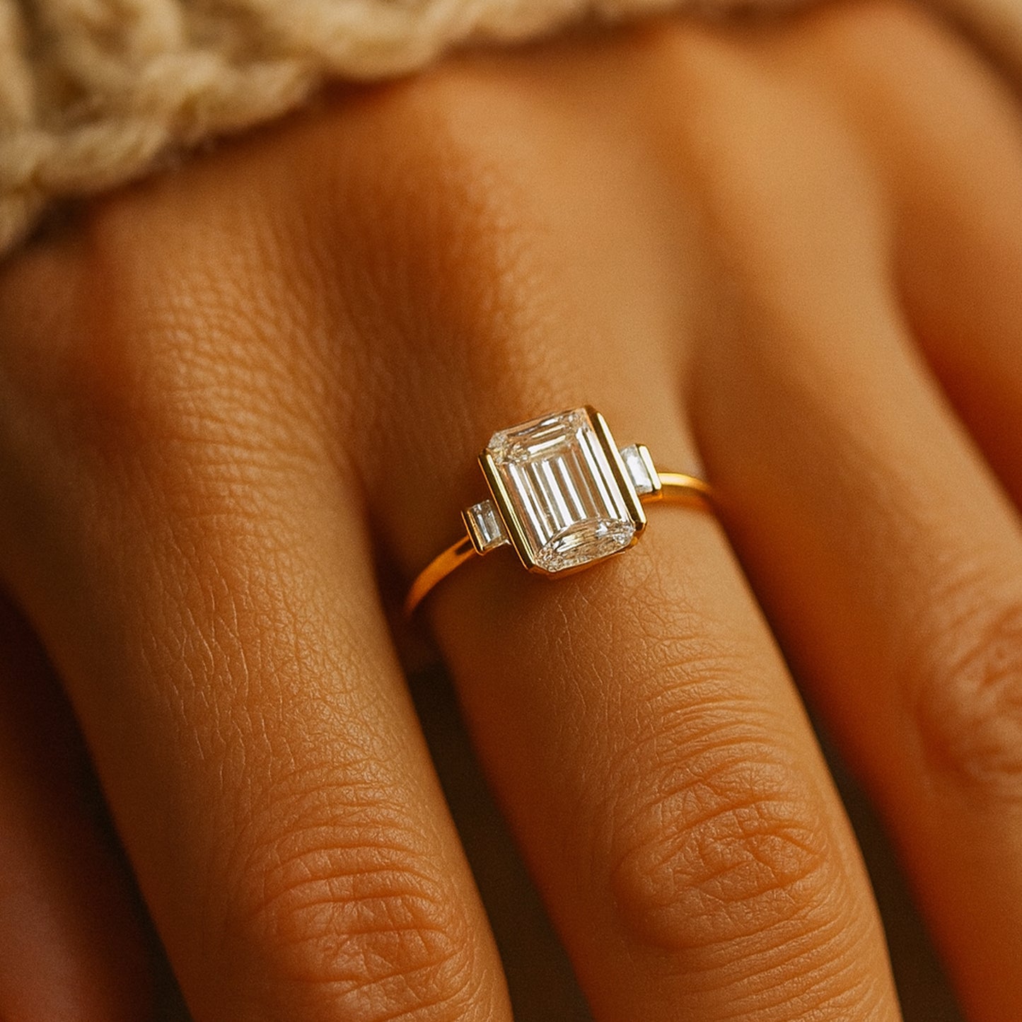 Elegant Emerald Cut Diamond Engagement Ring In 18K Yellow Gold Featuring Tapered Baguette Side Stones.