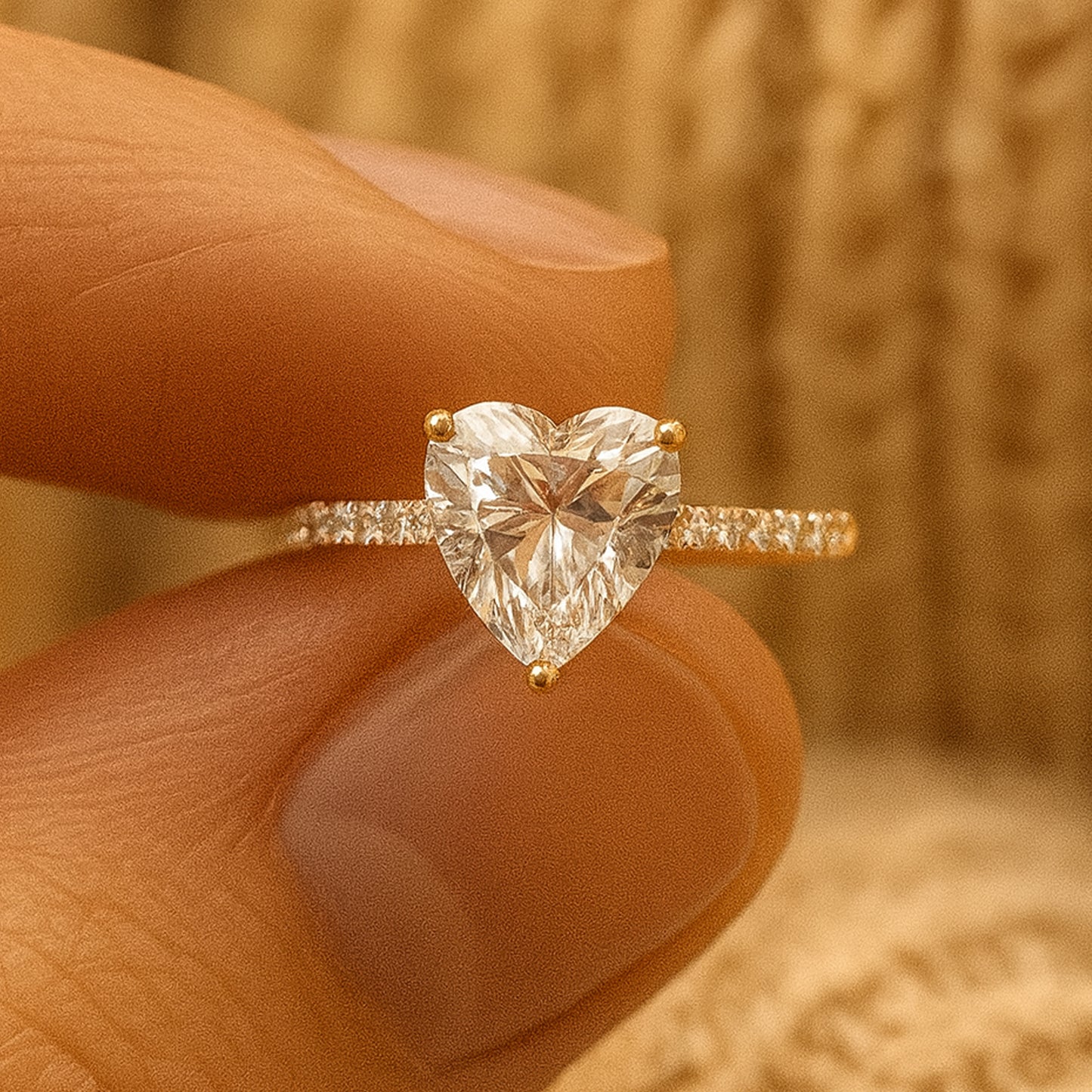 Woman wearing heart cut diamond engagement ring on finger