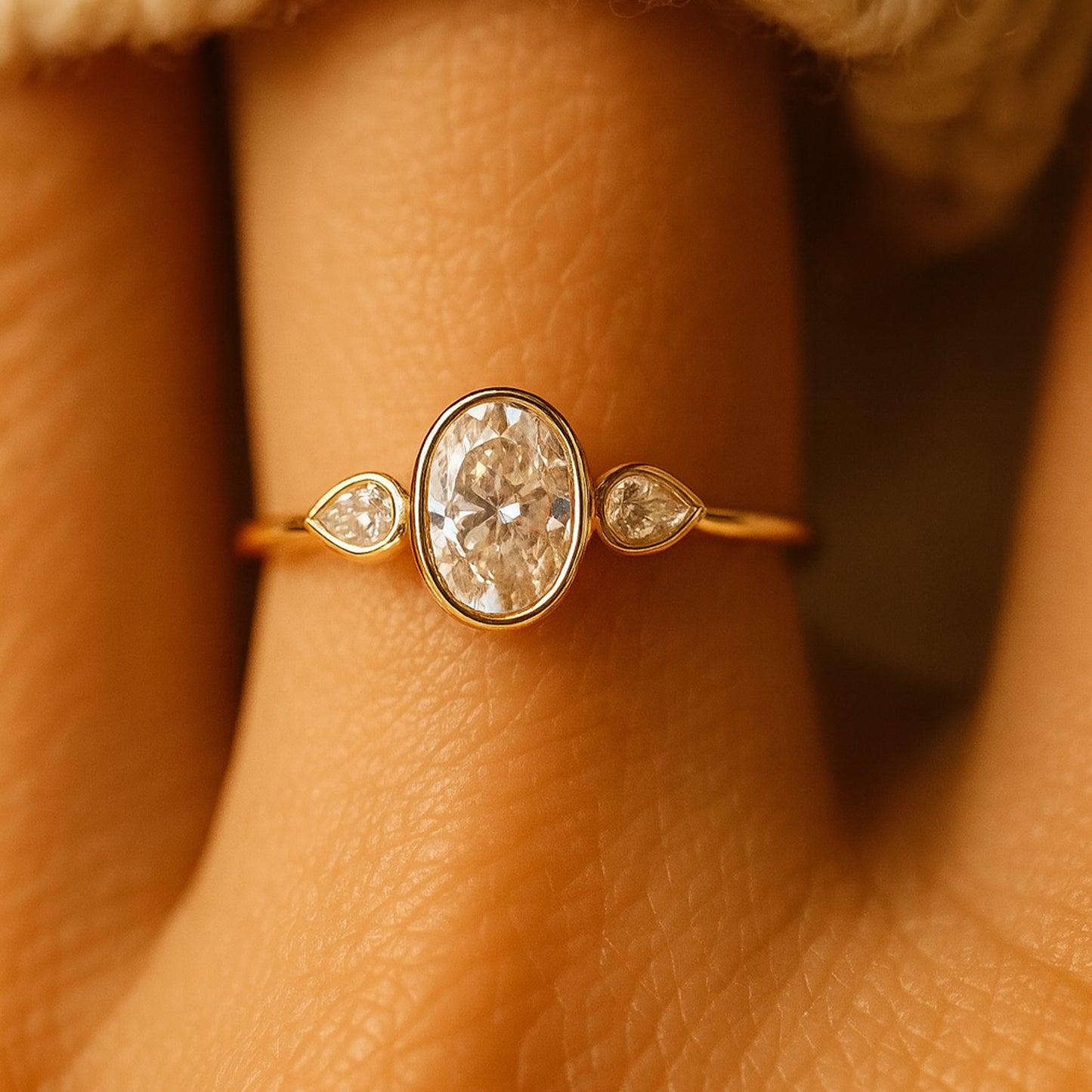 Elegant Oval Moissanite Bezel Set Ring With Pear Side Stones Featuring Diamond-Like Brilliance And Sparkle