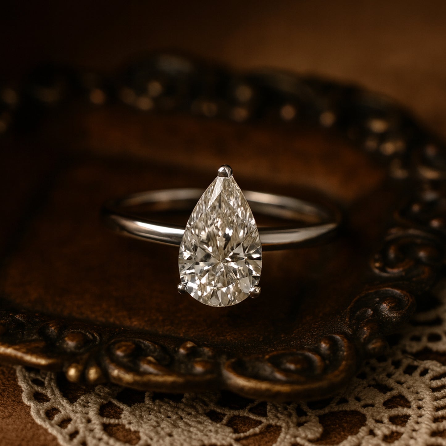 Classic 10K White Gold Solitaire Ring Featuring Brilliant Pear Cut Moissanite Stone.