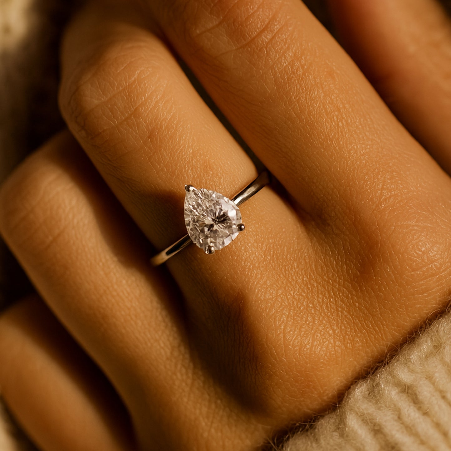 Three Stone Diamond Ring Close-Up Showing Cushion Center And Pear Accents