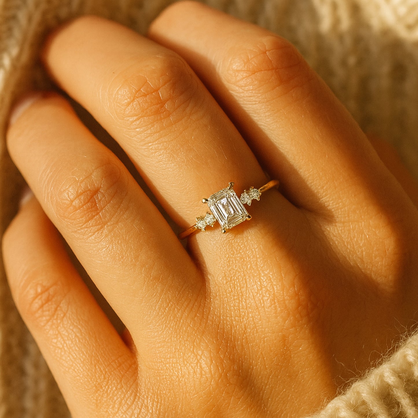 Elegant Three Stone Moissanite Ring Showcasing Emerald Cut Center And Sparkling Side Accents For Timeless Sophistication.