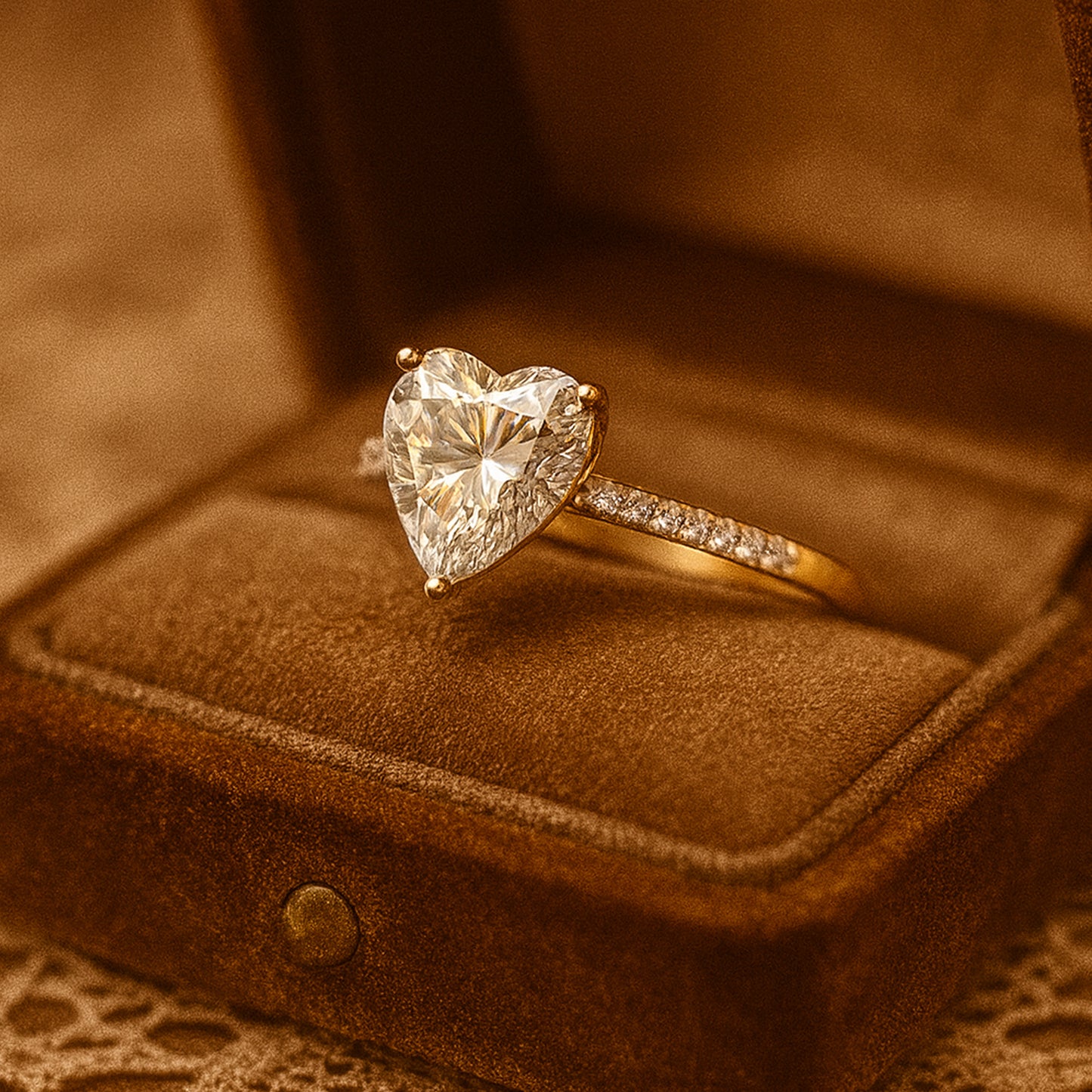 Diiro heart diamond engagement ring held between fingers, radiant sparkle and refined design