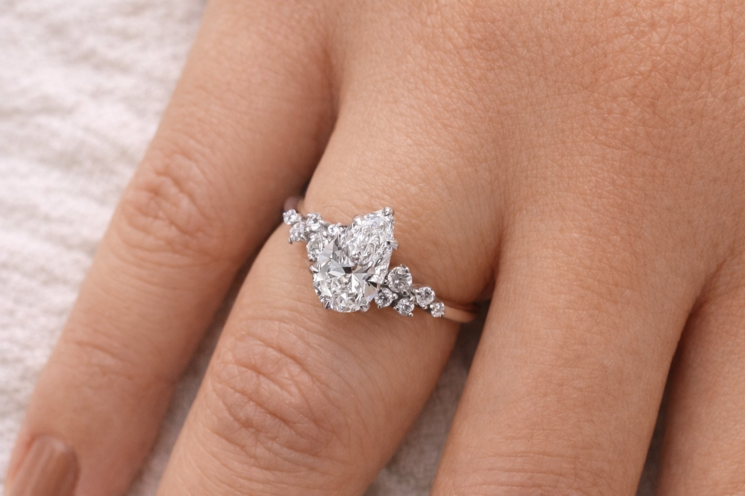 Teardrop Diamond Ring Round Cut Diamond Side Stone Yellow Gold.
