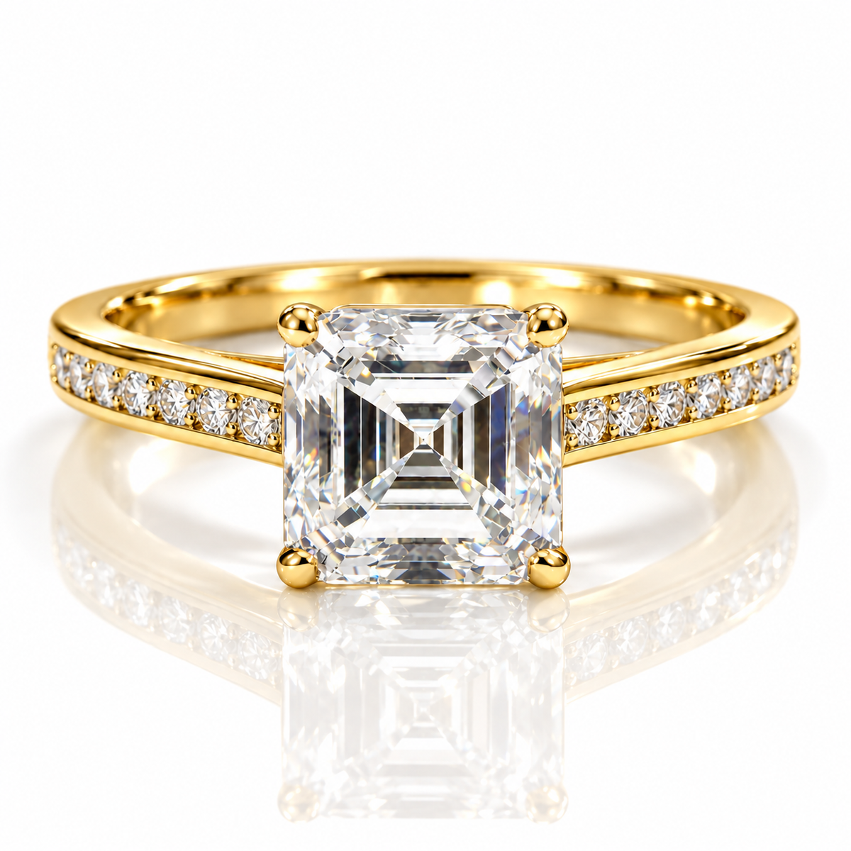 Gold Asscher-cut engagement ring with pavé diamond band on white background.
