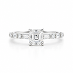 Emerald cut diamond engagement ring in polished silver with a four-prong setting, alternating baguette and round diamond side stones, and a pavé band.