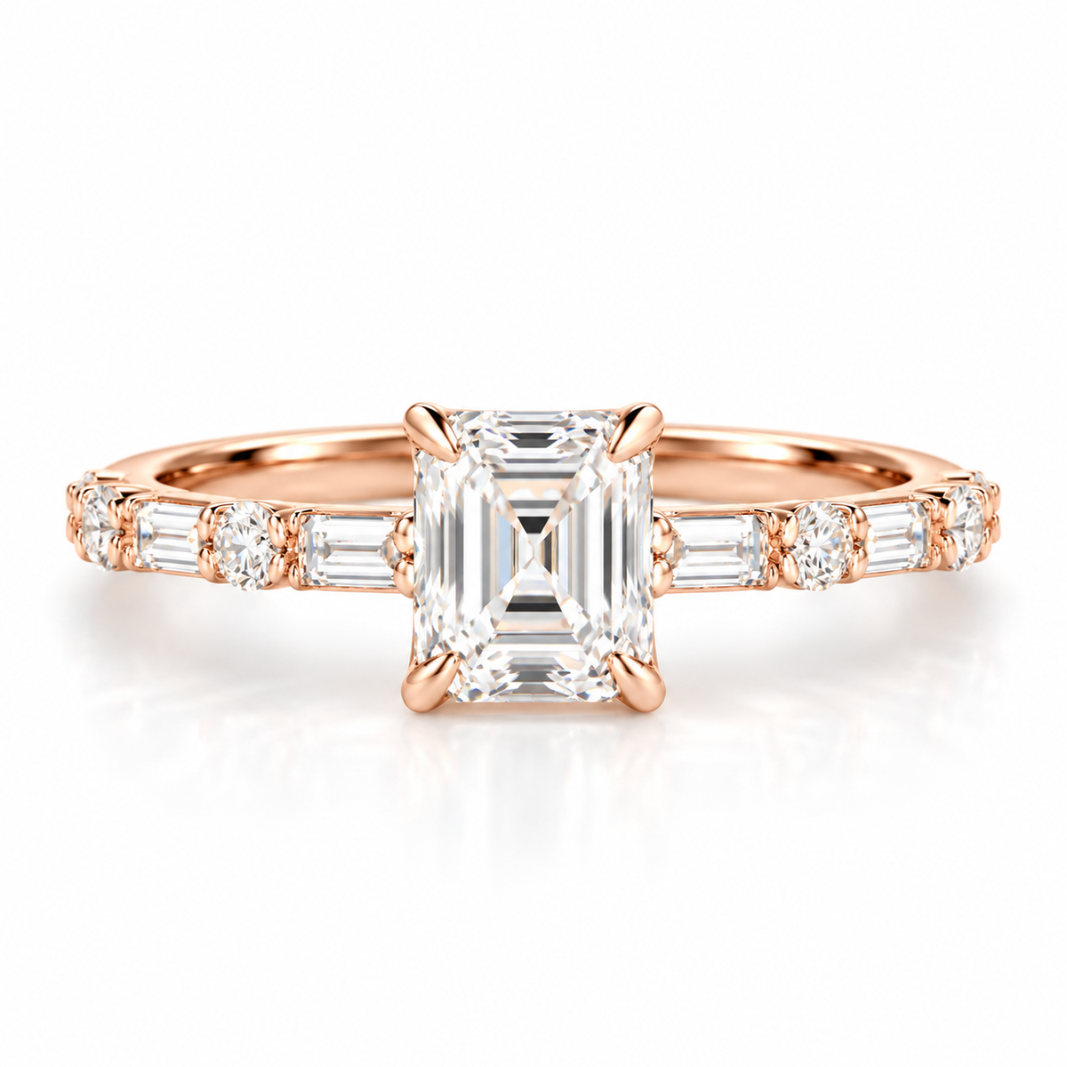 Emerald cut diamond engagement ring in 18K rose gold vermeil with a four-prong setting, alternating baguette and round diamond side stones, and a pavé band.