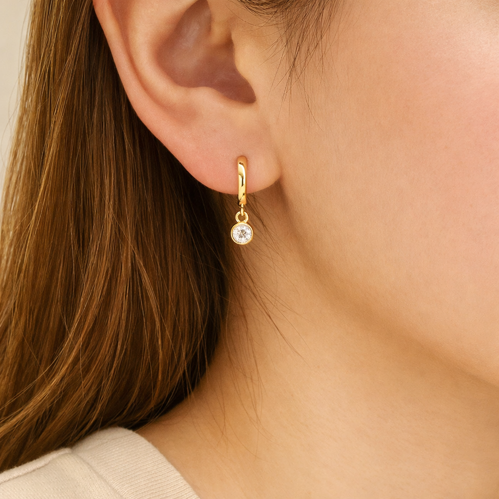 Gold Diamond Huggie Earrings With Bezel Set Round Cut Stone
