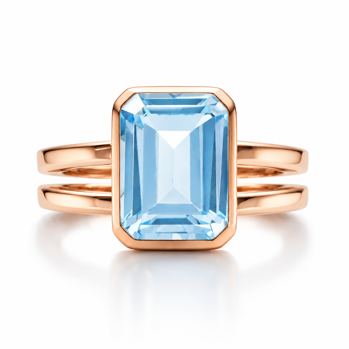 18K rose gold emerald cut blue gemstone ring with polished bezel setting and double band design for elegant luxury jewelry