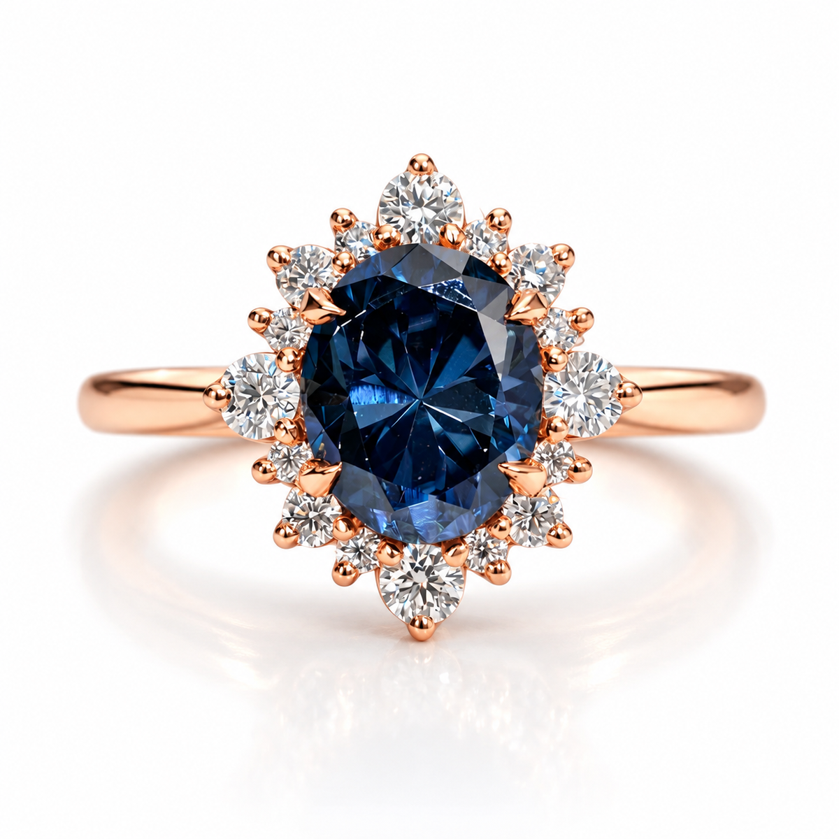Rose gold sapphire halo engagement ring with a deep blue round gemstone, surrounded by brilliant diamond accents in a floral cluster setting with polished rose gold band.
