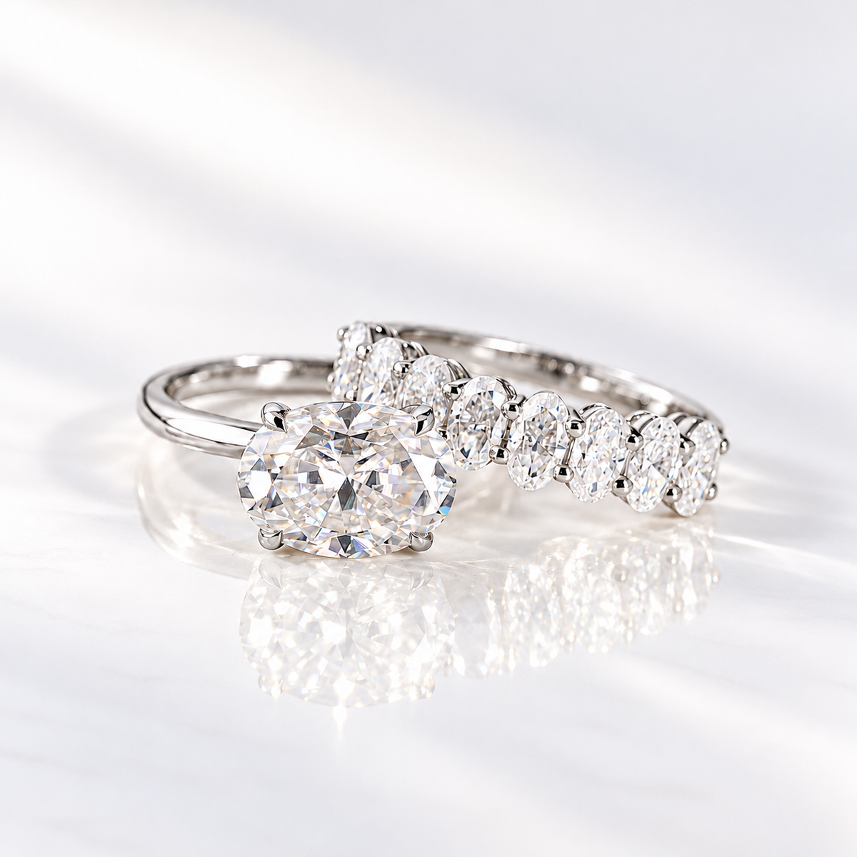 East west oval cut clear ring stone with bright brilliant facets and sparkling white light, held by four prongs