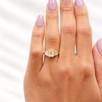 Emerald cut diamond center stone in a yellow gold bezel setting, flanked by two graduated baguette side stones on each side
