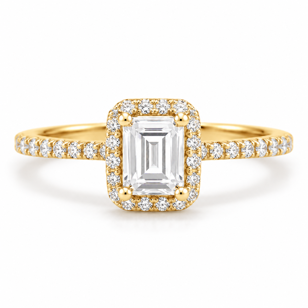 18K yellow gold emerald cut engagement ring with rectangular pavé diamond halo, four-prong setting, and diamond accented band