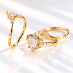 Angled view of an emerald cut colorless ring stone with long parallel facets, four prongs, and small round and marquise accent stones