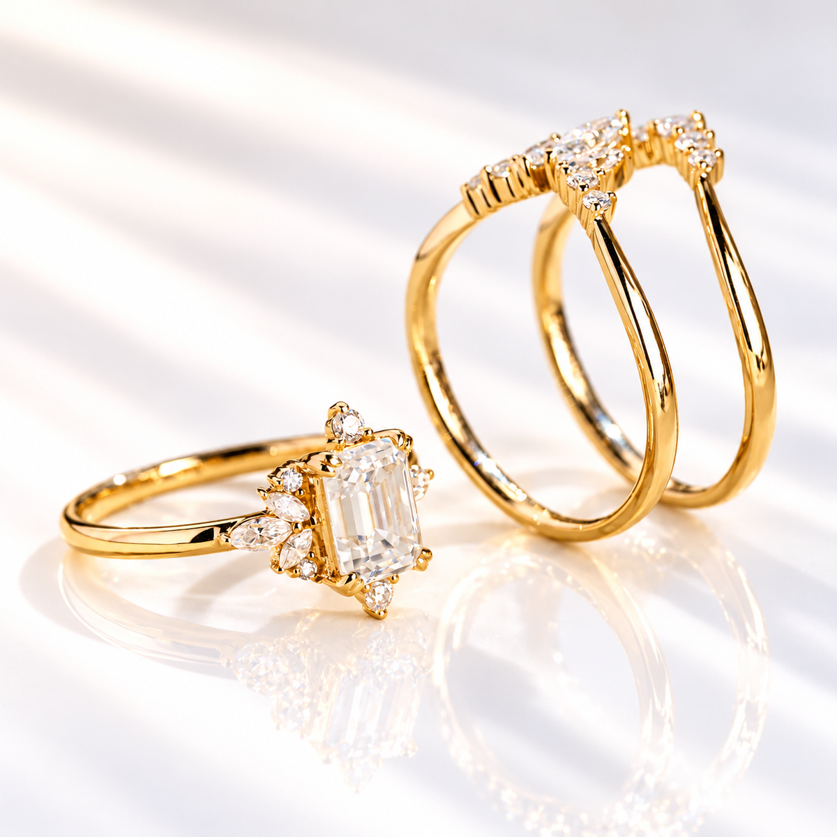 Emerald cut colorless ring stone with a clear table and sharp step cut facets, flanked by small marquise accent stones