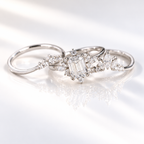 Emerald cut clear ring stone with a clean rectangular shape and bright step cut facets, surrounded by small accent stones