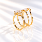 Top angle of an emerald cut colorless ring stone with a wide table, long step facets, and small marquise accent stones
