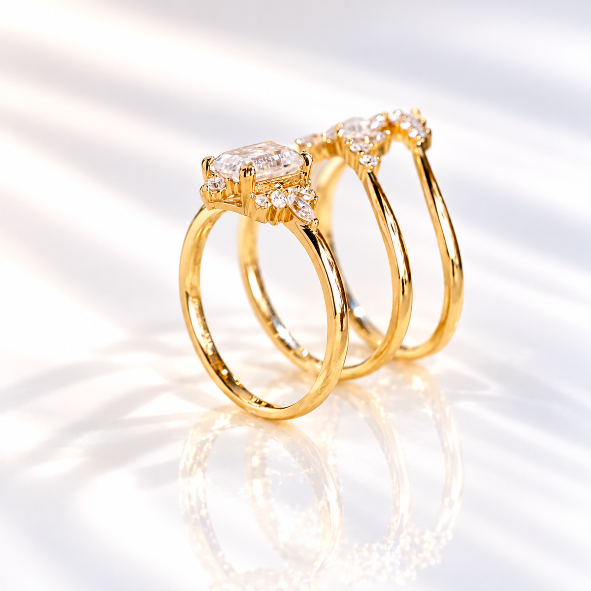 Top angle of an emerald cut colorless ring stone with a wide table, long step facets, and small marquise accent stones