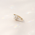 Yellow Gold Three Stone Engagement Ring Featuring Pear Cut Side Stones
