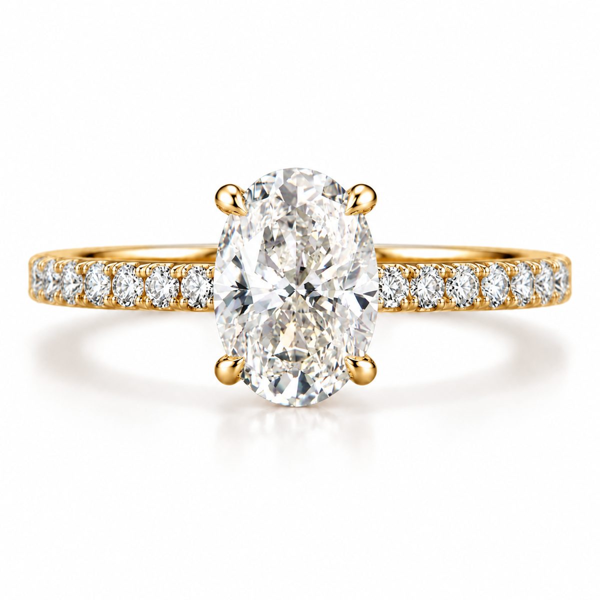 Oval cut diamond solitaire engagement ring in yellow gold with a four-prong setting, featuring a sparkling oval center stone and a pavé diamond band with round accent diamonds along the shank.