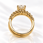 Head-on view of a yellow gold engagement ring showing the overlapping split bands, graduated diamond row, and the pavé hidden halo under the oval center stone.