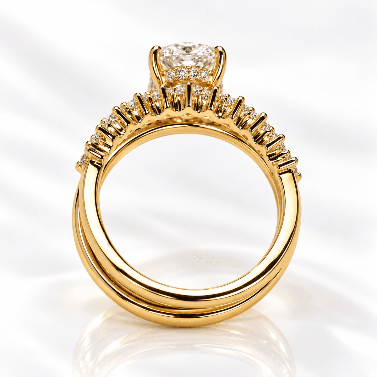 Head-on view of a yellow gold engagement ring showing the overlapping split bands, graduated diamond row, and the pavé hidden halo under the oval center stone.