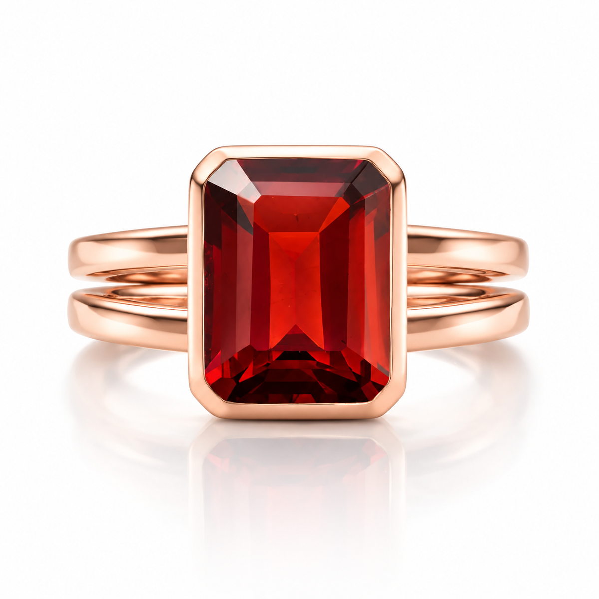 Rose gold emerald cut garnet ring with bezel setting
