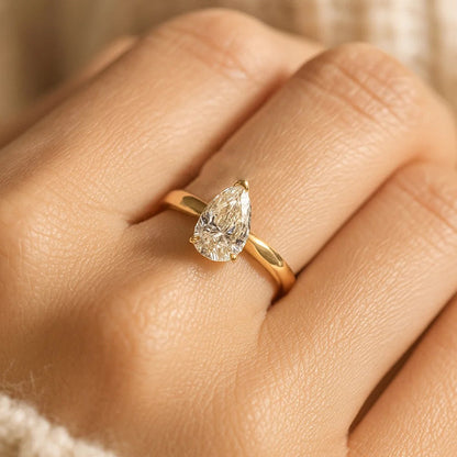 Golden Pear Moissanite Engagement Ring With Classic Setting And Diamond Alternative Appeal.