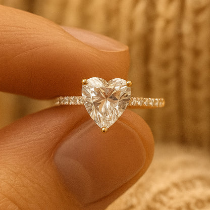 Woman wearing heart cut diamond engagement ring on finger