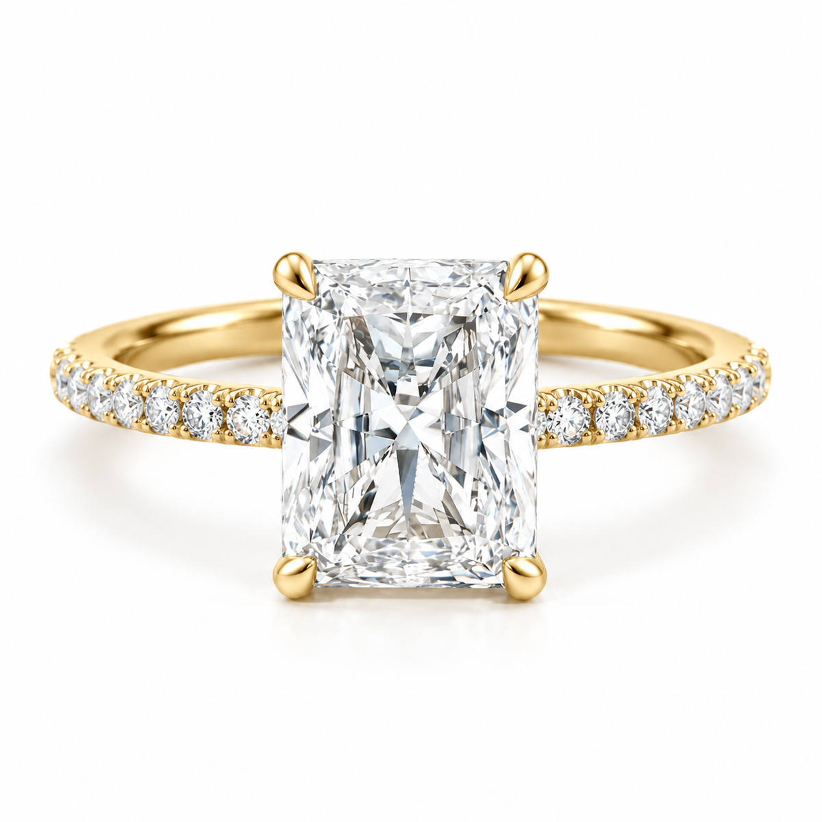 Radiant cut diamond engagement ring in polished yellow gold with a slim pavé diamond band and four-prong setting.
