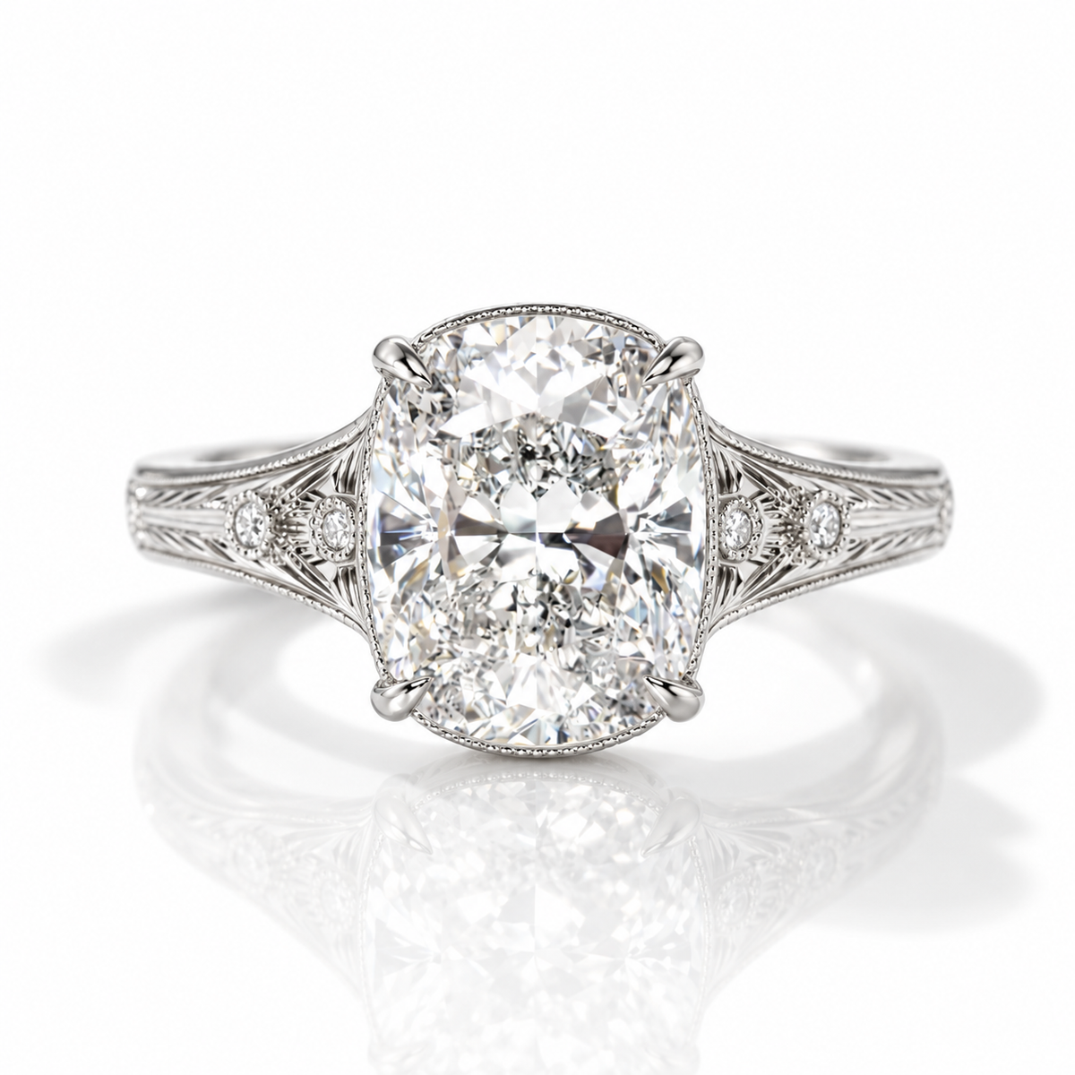 Silver vintage-inspired cushion-cut engagement ring with engraved filigree shoulders and accent diamonds.