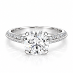 Round brilliant cut diamond engagement ring in polished silver with a double pavé diamond band and four-prong solitaire setting.