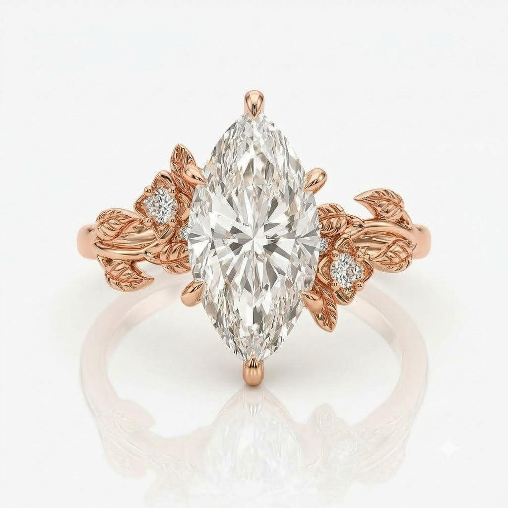 Rose gold ring with a large marquise-cut clear center stone and small round stones set in leaf-shaped side details, shown on a clean white background with a soft reflection below.