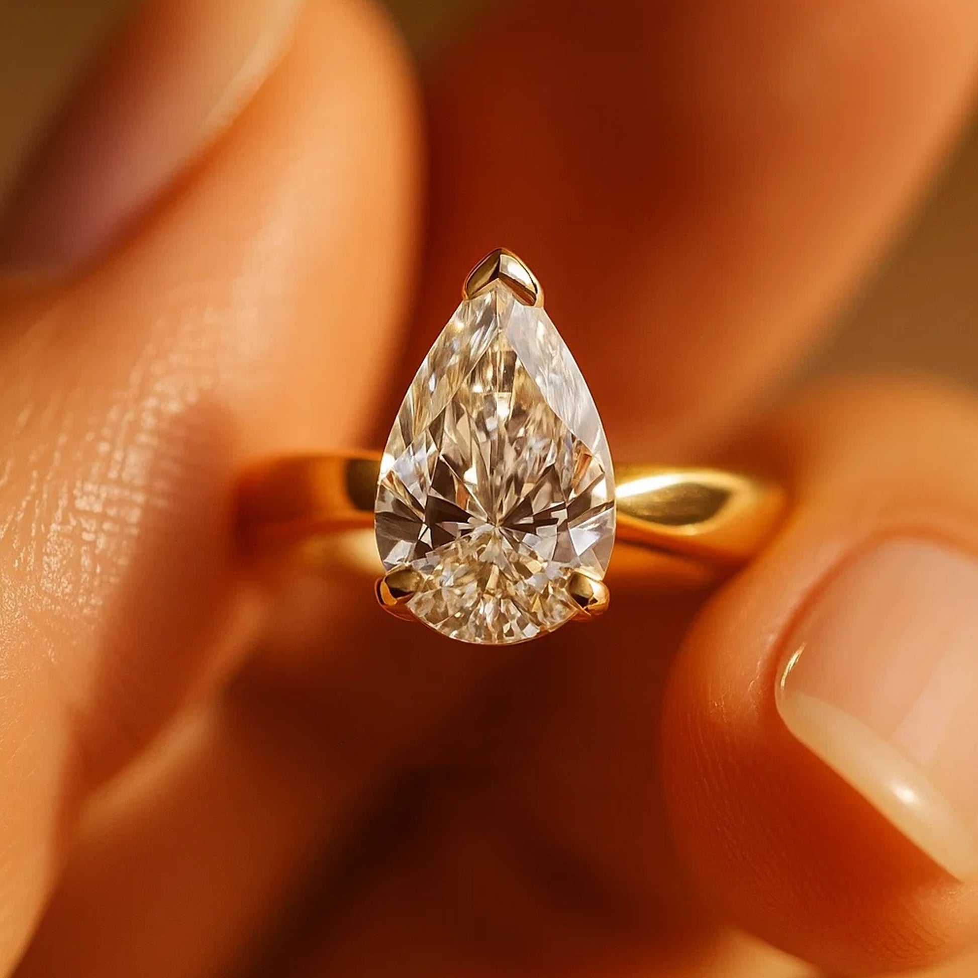 Dainty Pear Shaped Moissanite Solitaire Ring Reflecting Diamond-Like Brilliance And Romantic Glow.