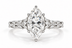 Polished silver marquise diamond engagement ring with floral diamond accents