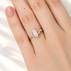 Marquise cut diamond center stone with marquise and round side stones in a yellow gold prong setting