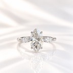 Marquise cut diamond center stone in a four-prong white gold setting, flanked by a marquise cut side stone on each side
