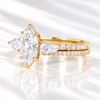 Angled view of a marquise cut colorless ring stone with elongated facets, six prongs, and a hidden halo of small stones