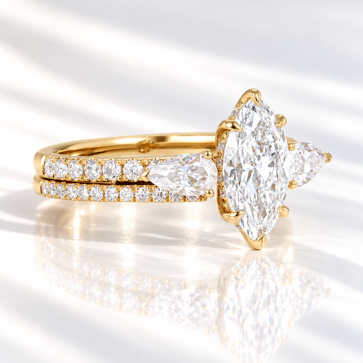 Side angle of a marquise cut ring stone showing its depth, brilliant facets, and six-prong setting with a hidden halo beneath