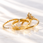 Back view of a marquise cut ring stone showing its pavilion facets and prong setting, with small accent stones around it