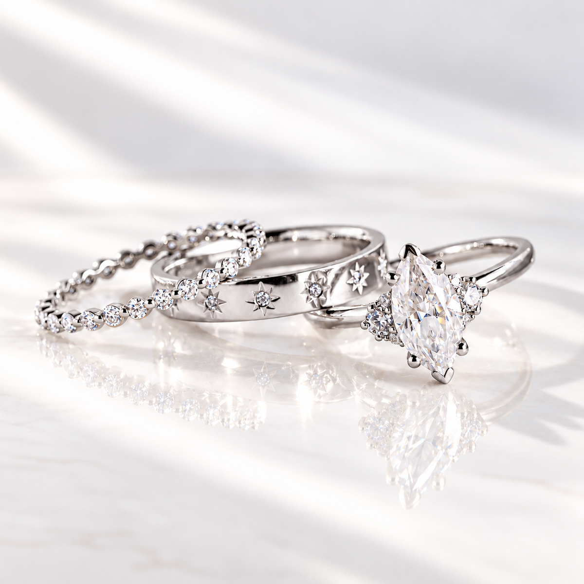 Marquise cut colorless ring stone with brilliant facets and pointed ends, held by prongs with small round accent stones on both sides