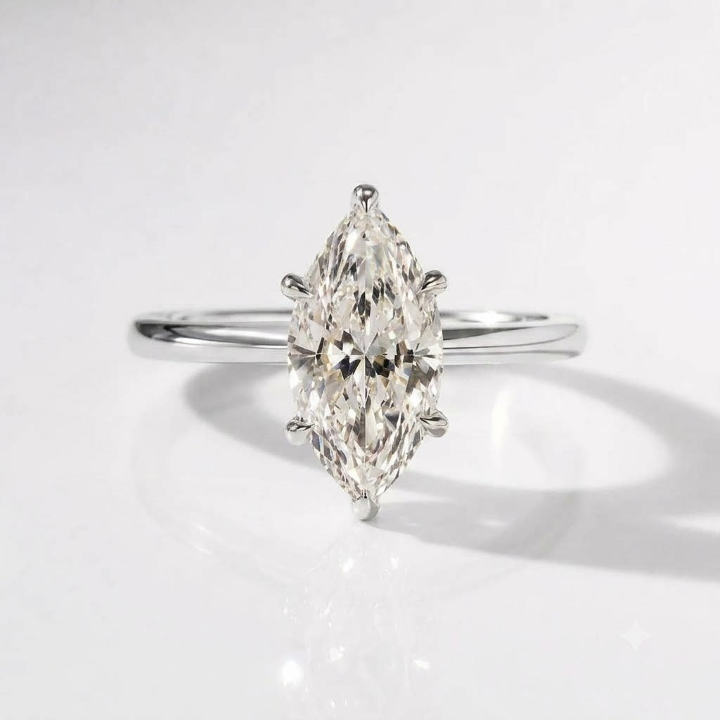Polished sterling silver engagement ring featuring a large marquise-cut solitaire moissanite held in a six-prong setting with a sleek, rounded band.
