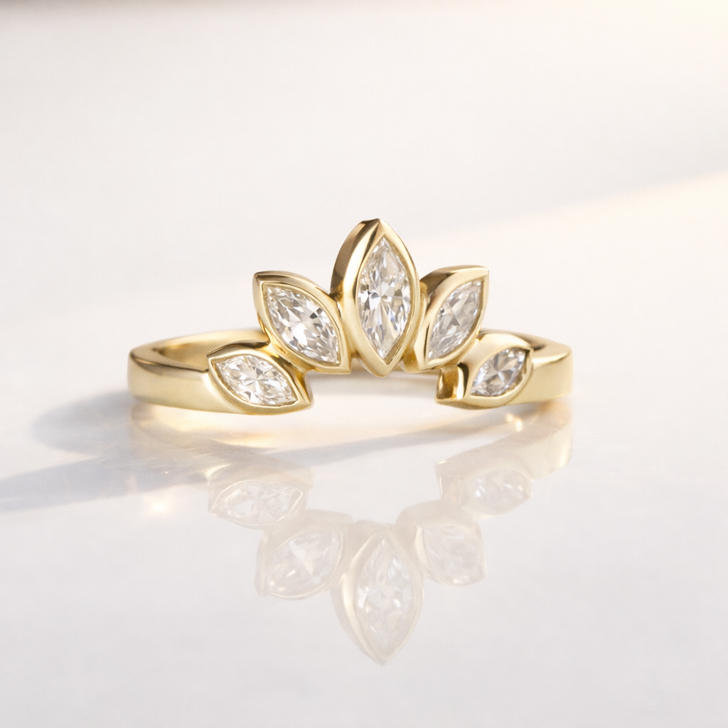 Gold band with diamond accents on a reflective surface