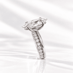 Side profile of a marquise diamond engagement ring with a pavé diamond band, set in white gold on a soft white background.