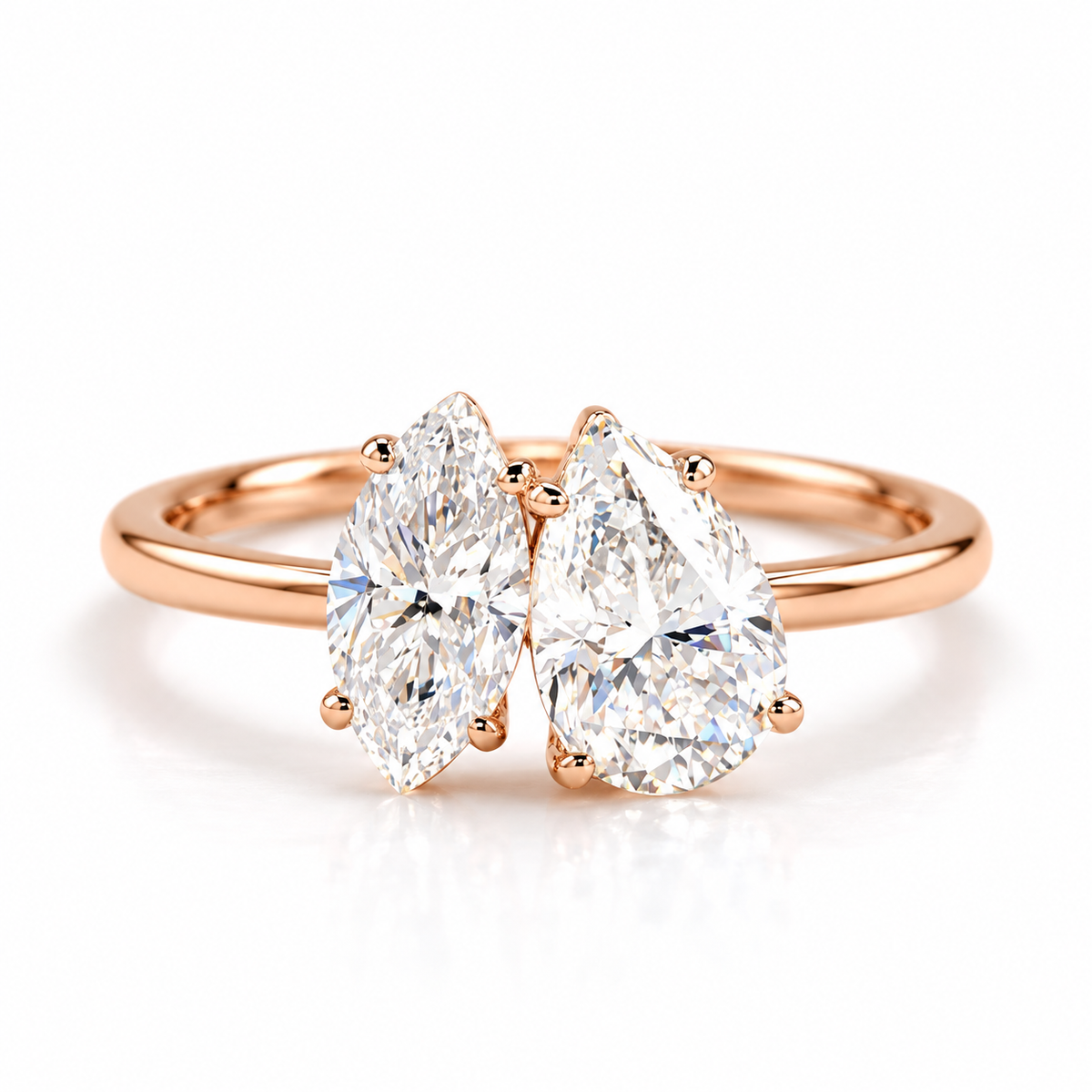 18K rose gold vermeil bypass ring featuring two pear-shaped sparkling gemstones with polished metal prong settings