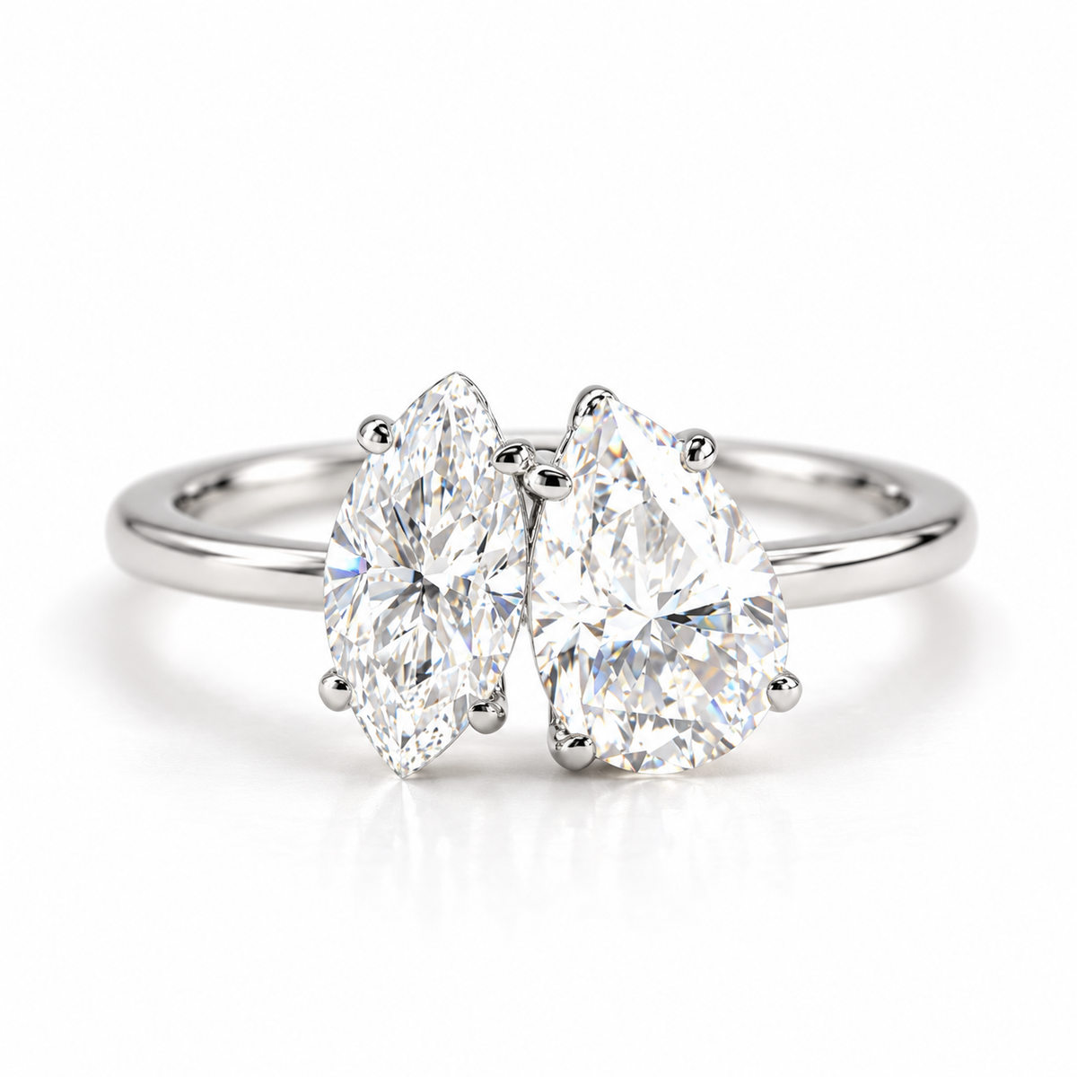 Polished silver bypass ring featuring two pear-shaped sparkling gemstones with sleek metal prong settings