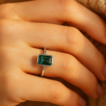 Engagement Emerald Cut Green Gemstone Ring On Hand In Natural Light