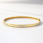 Gold bracelet stack with emerald cut diamond bracelets

